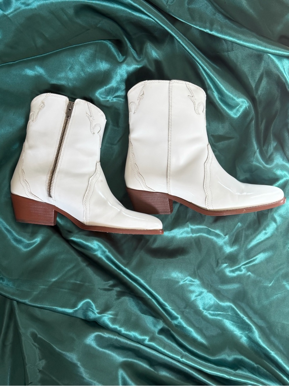 pair of white patent leather Free People New Frontier Western Boots featuring po